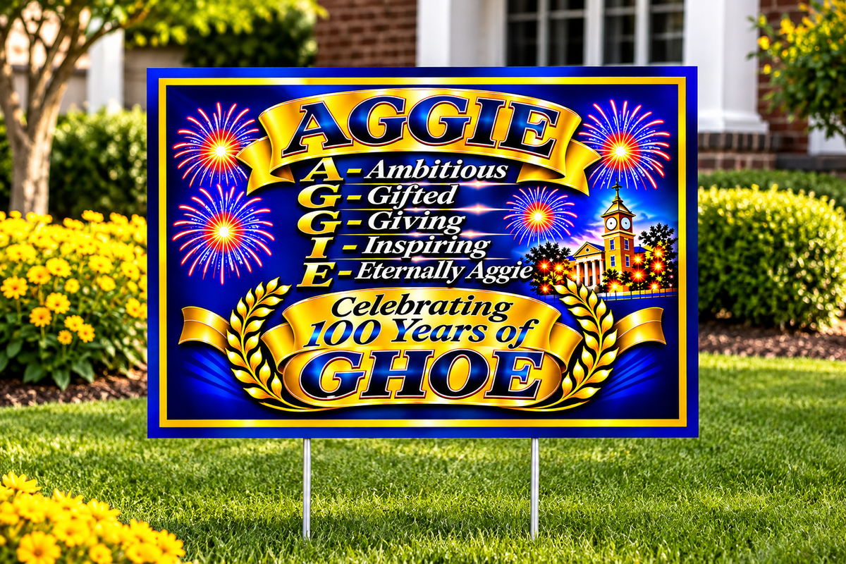 Blue-and-gold Aggie yard sign with fireworks, the AGGIE tribute, and Celebrating 100 Years of GHOE lettering.